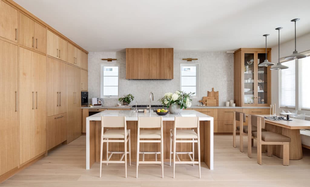 Eat-in kitchen with island seating in Manhattan Beach Elevated Coastal home built by RJ Smith Construction